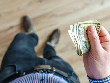 https://www.pexels.com/photo/man-holds-10-u-s-dollar-banknote-928201/