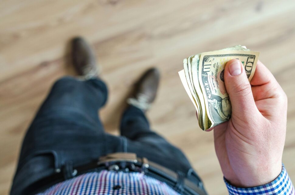 https://www.pexels.com/photo/man-holds-10-u-s-dollar-banknote-928201/
