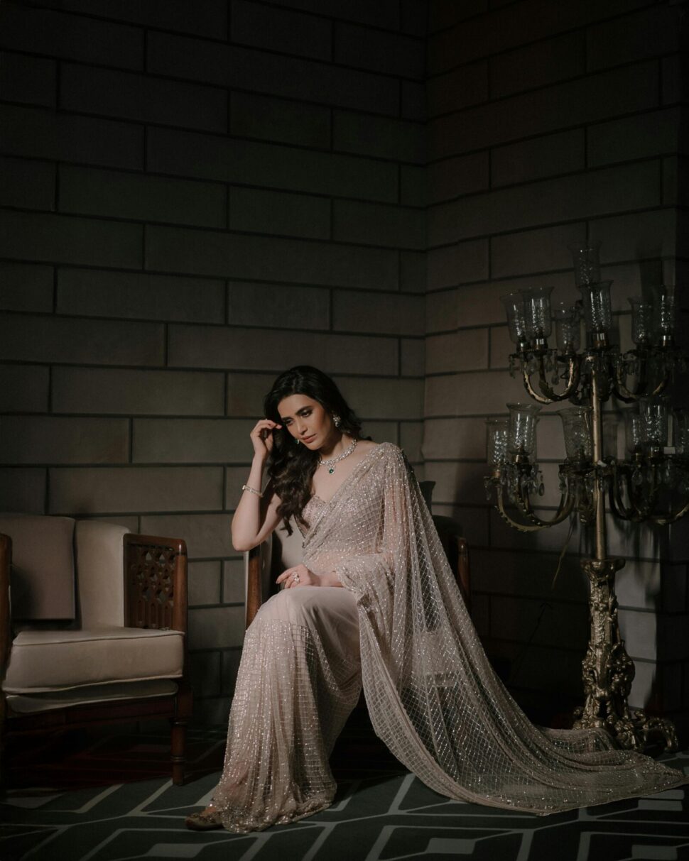 https://www.pexels.com/photo/elegant-woman-in-shimmering-saree-sitting-indoors-30249387/