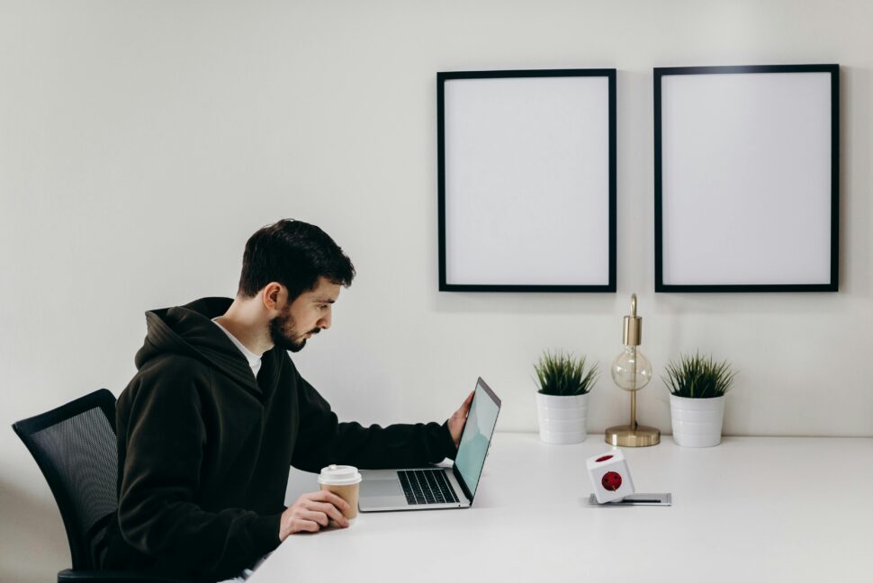 https://www.pexels.com/photo/man-in-black-coat-sitting-at-the-table-4064840/