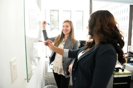 https://www.pexels.com/photo/two-women-in-front-of-dry-erase-board-1181533/