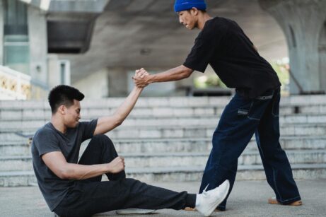 https://www.pexels.com/photo/asian-man-helping-friend-to-get-up-from-ground-5368943/