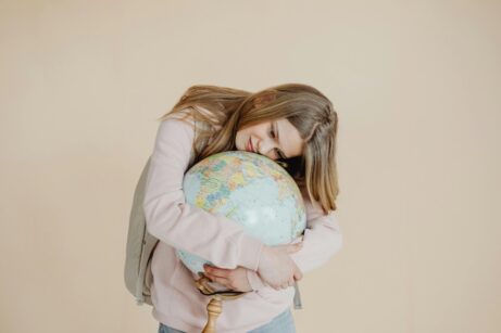 https://www.pexels.com/photo/a-young-girl-hugging-a-globe-8147391/