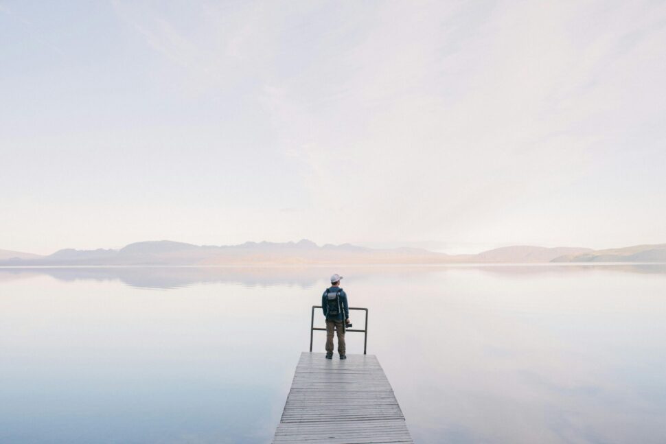 https://www.pexels.com/photo/man-wearing-jacket-standing-on-wooden-docks-leading-to-body-of-water-571169/