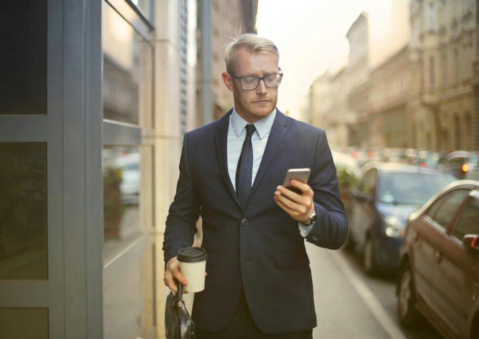https://www.pexels.com/photo/selective-focus-photo-of-walking-man-in-black-suit-carrying-a-to-go-cup-and-briefcase-while-using-his-phone-3771076/