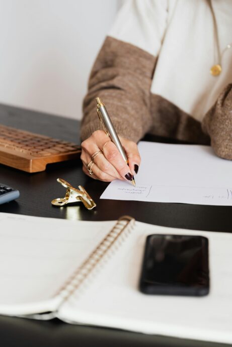 https://www.pexels.com/photo/crop-elegant-business-lady-taking-notes-while-sitting-at-desk-4491492/