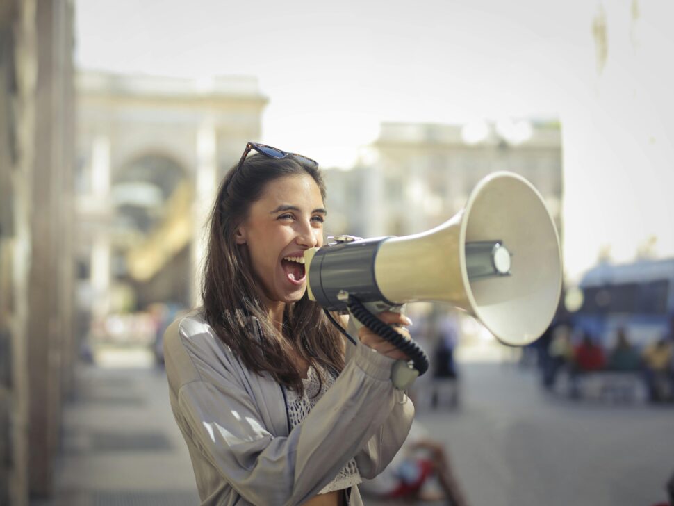 https://www.pexels.com/photo/cheerful-young-woman-screaming-into-megaphone-3761509/