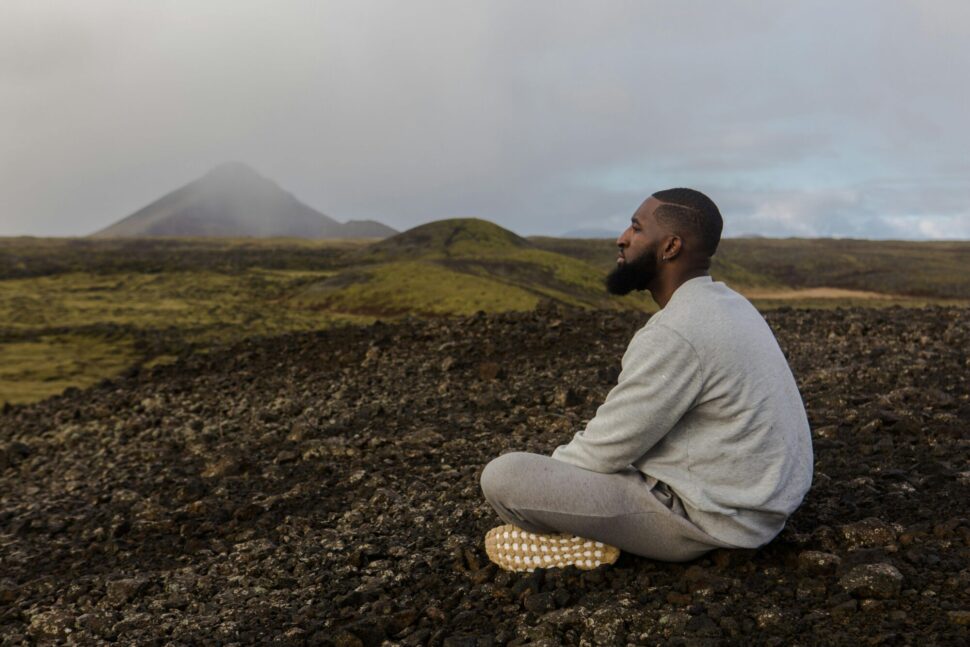 https://www.pexels.com/photo/man-in-white-top-sitting-on-brown-soil-1058952/