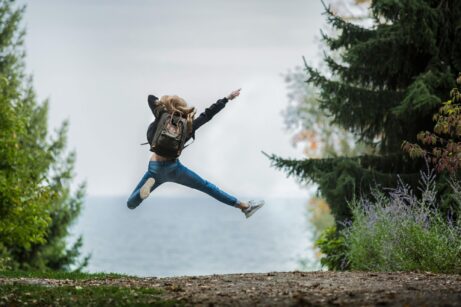 https://www.pexels.com/photo/woman-jumping-wearing-green-backpack-214574/