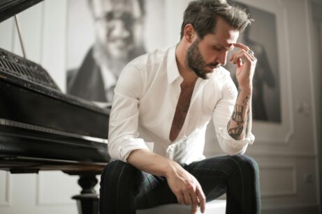 https://www.pexels.com/photo/dramatic-tattooed-male-sitting-at-piano-3760269/