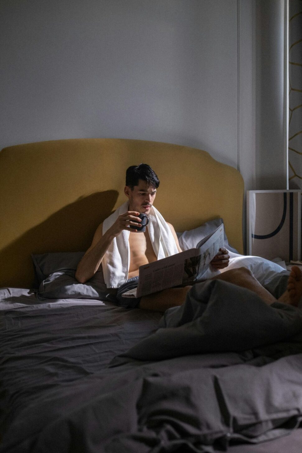 https://www.pexels.com/photo/a-man-reading-a-newspaper-while-in-bed-9615251/