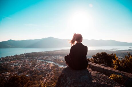 https://www.pexels.com/photo/woman-sitting-at-the-edge-of-mountain-2261017/