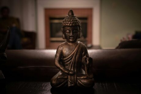 https://www.pexels.com/photo/brass-buddha-figurine-on-black-surface-1585716/