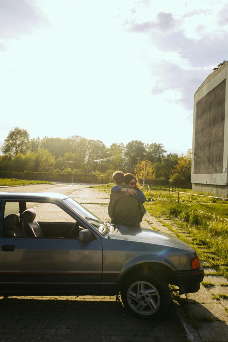 https://www.pexels.com/photo/woman-in-white-long-sleeve-shirt-sitting-on-gray-car-8104856/