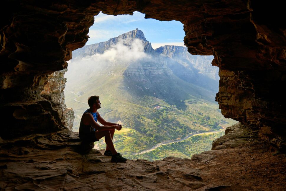 https://www.pexels.com/photo/photo-of-man-sitting-on-a-cave-1659437/