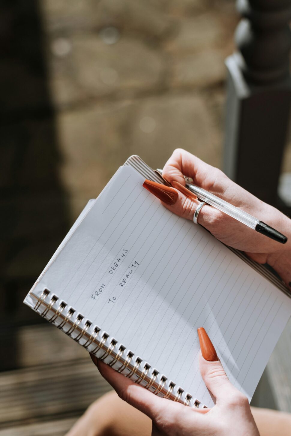 https://www.pexels.com/photo/woman-with-long-nails-writing-text-in-diary-7256738/