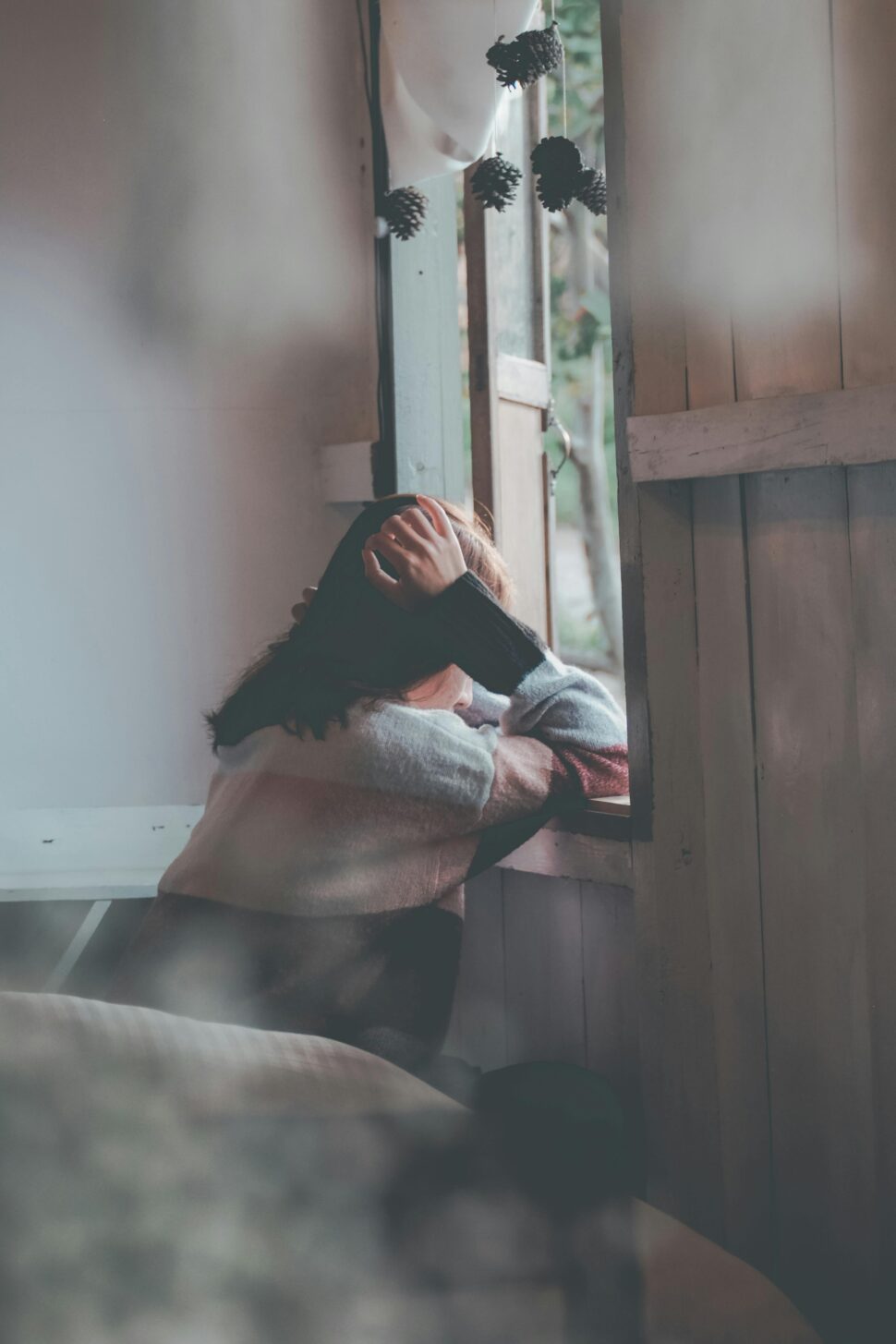 https://www.pexels.com/photo/photo-of-a-person-leaning-on-wooden-window-1510149/