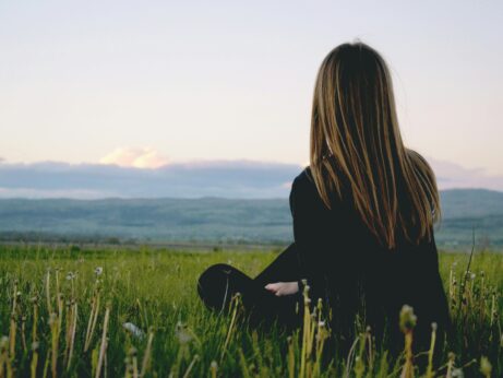 https://www.pexels.com/photo/woman-wearing-black-long-sleeved-shirt-sitting-on-green-grass-field-691919/