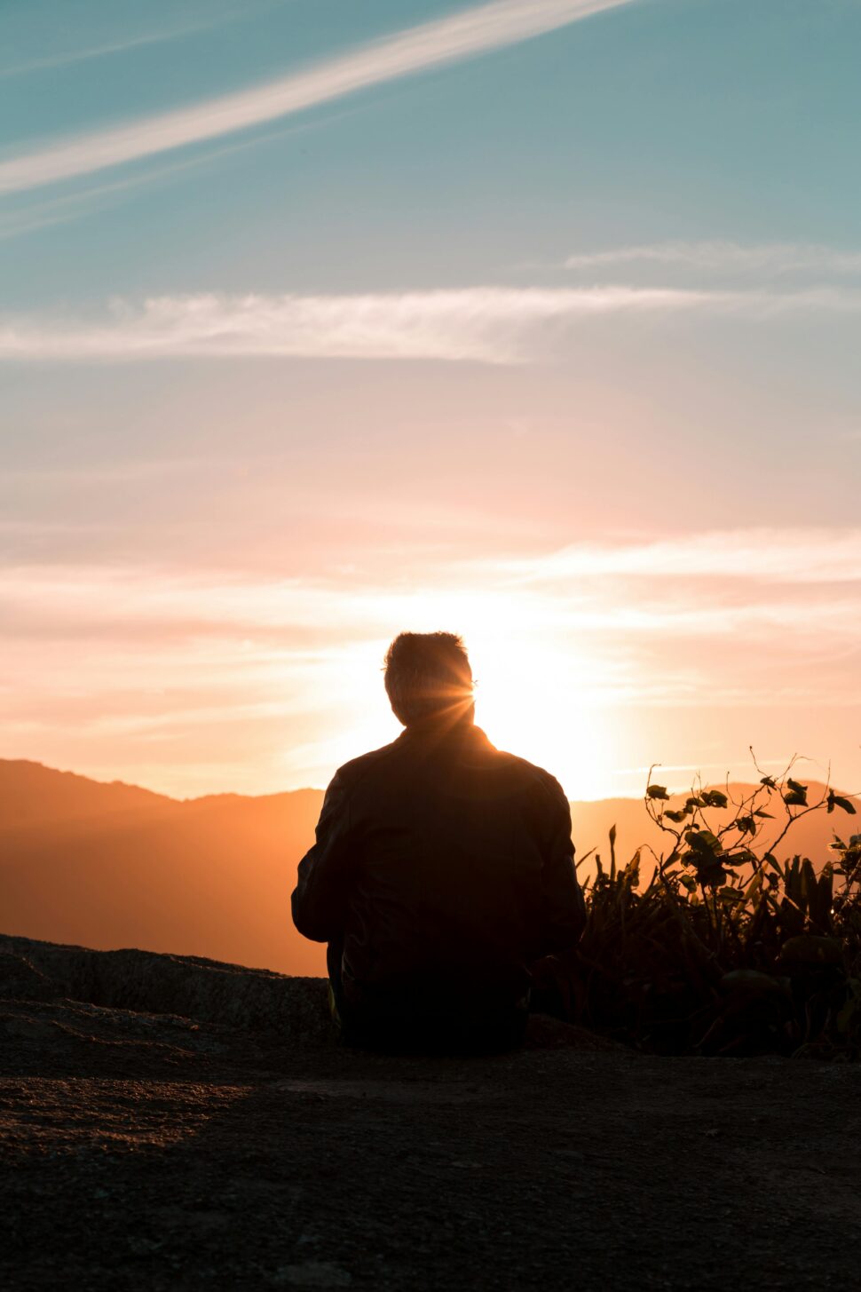 https://www.pexels.com/photo/silhouette-of-person-sitting-and-facing-mountain-during-sunset-2260959/